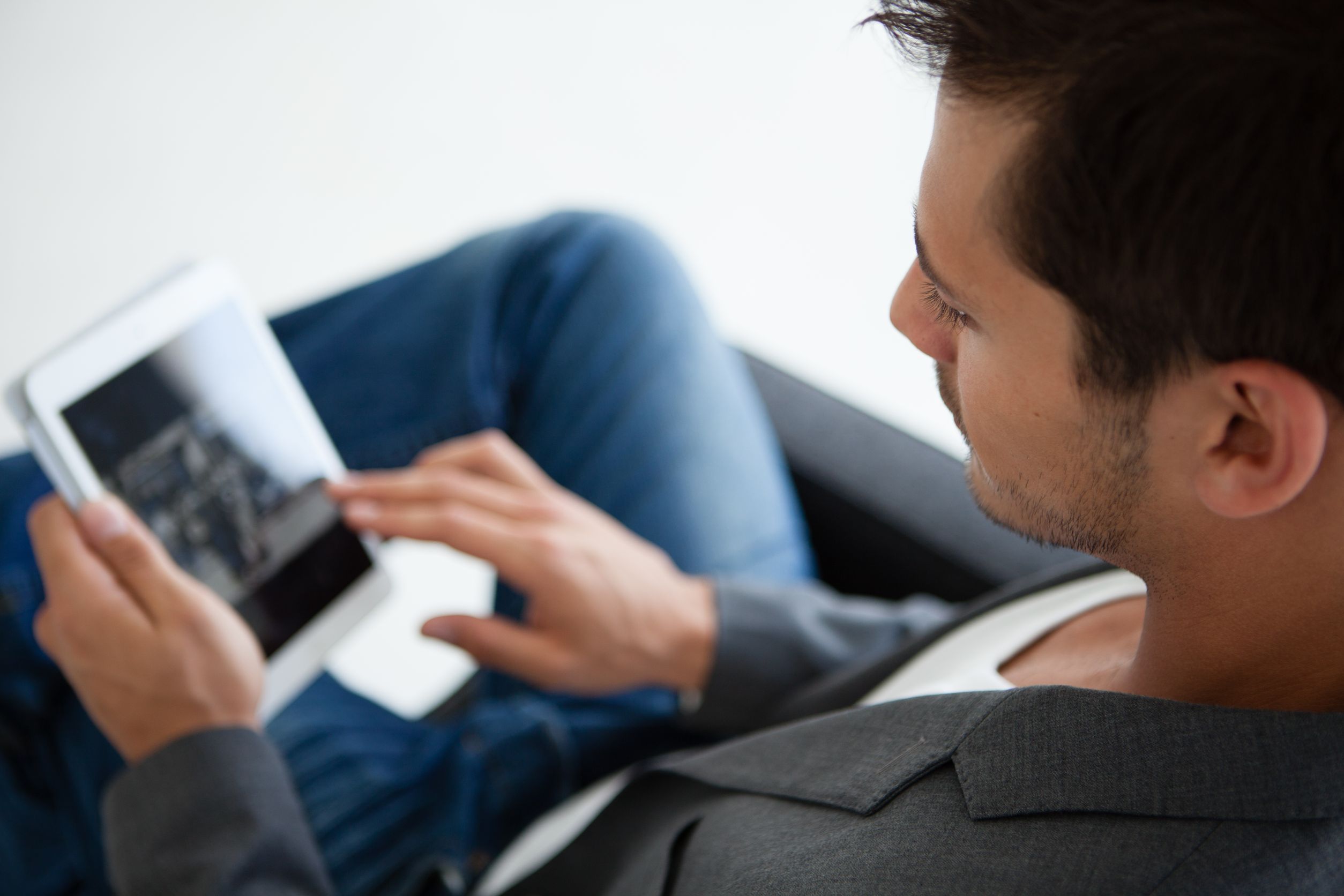 Professional young man working on tablet.